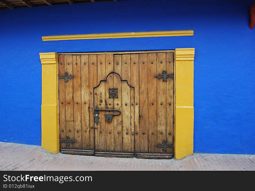 Blue and gold wall and wooden door. Blue and gold wall and wooden door