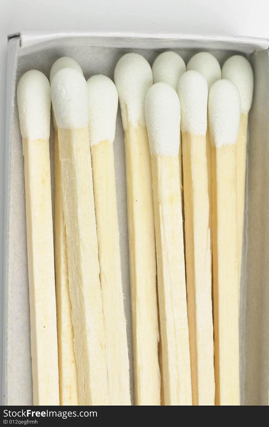 Wooden match sticks in paper matchbox - macro. Wooden match sticks in paper matchbox - macro