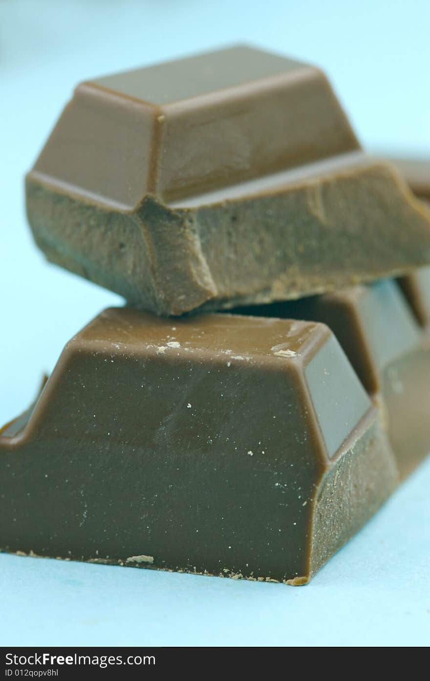 Milk chocolate isolated against a blue background