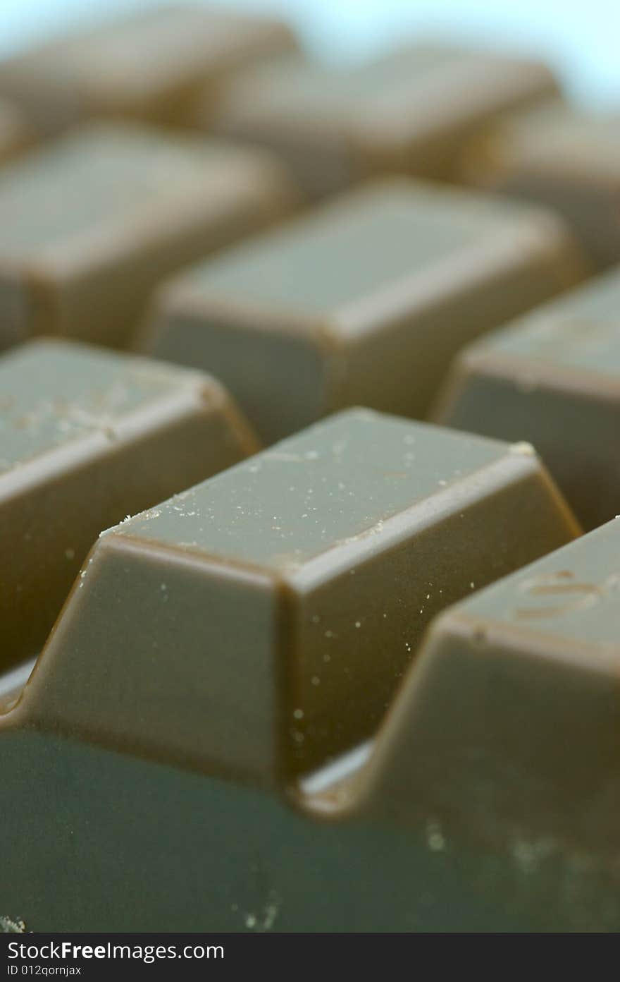 Milk chocolate isolated against a blue background