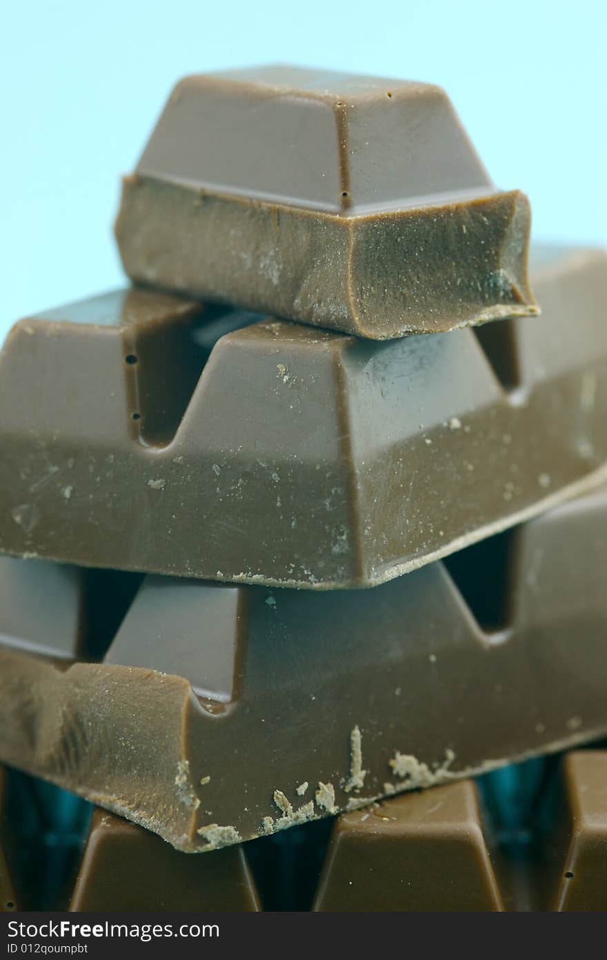 Milk chocolate isolated against a blue background