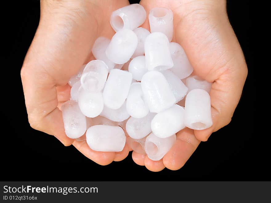 Pieces of ice in hand close up over black background. Pieces of ice in hand close up over black background