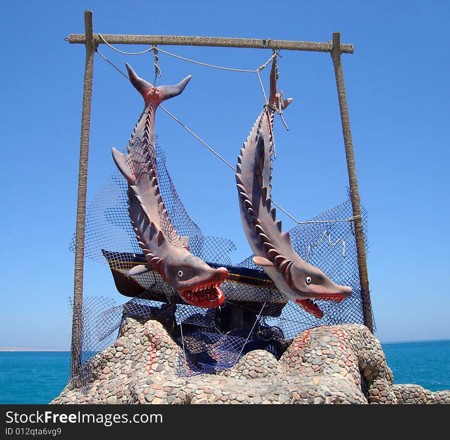 Detail of sculpture dedicated to sharks on funny way, Hurghada