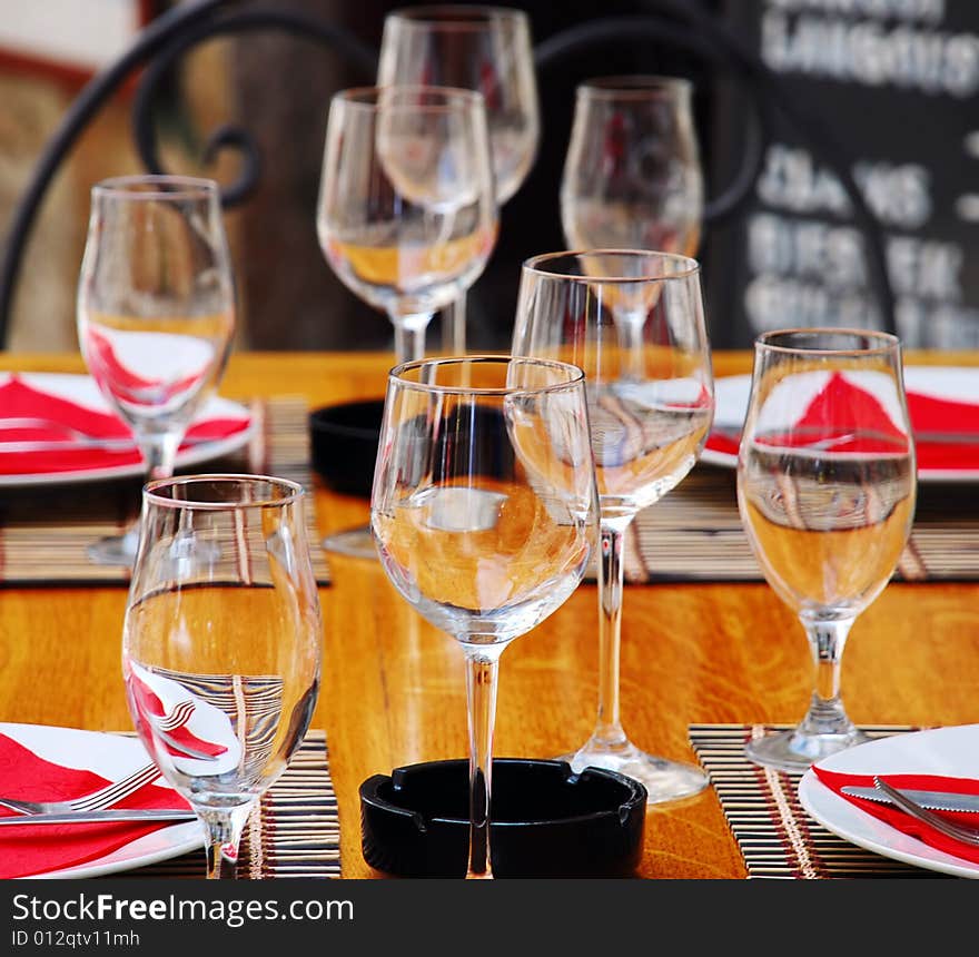 Wineglasses and plates on table in restaurant. Wineglasses and plates on table in restaurant