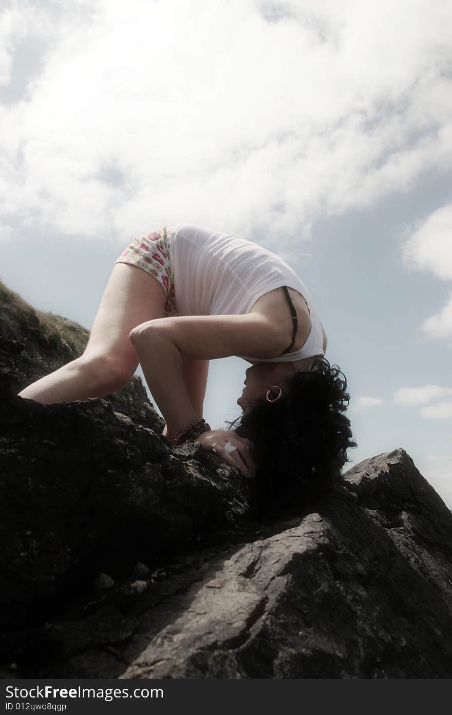 A beautiful woman doing yoga to show a healthy way to live a happy and relaxed lifestyle in a world full of stress. A beautiful woman doing yoga to show a healthy way to live a happy and relaxed lifestyle in a world full of stress