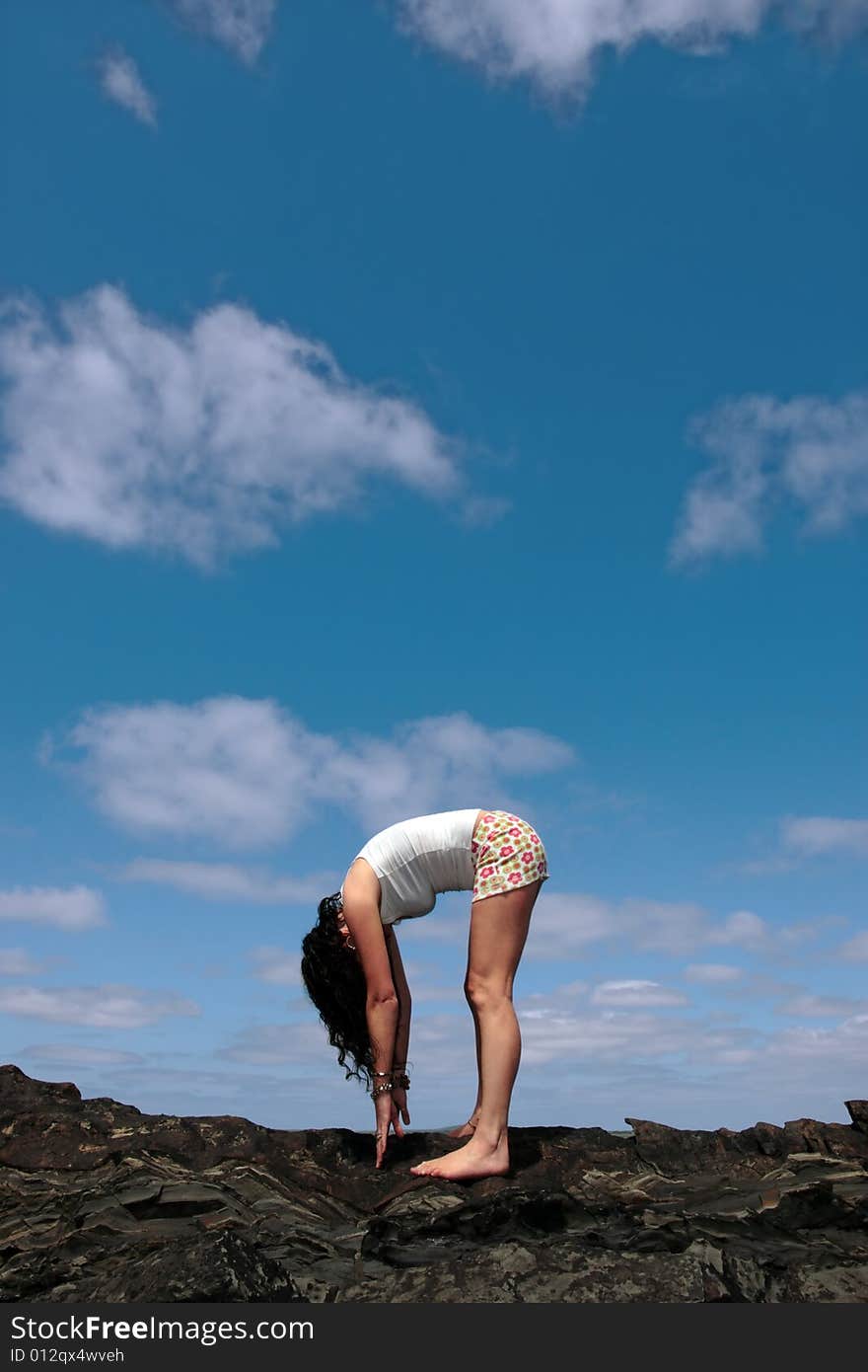 A beautiful woman doing yoga to show a healthy way to live a happy and relaxed lifestyle in a world full of stress. A beautiful woman doing yoga to show a healthy way to live a happy and relaxed lifestyle in a world full of stress