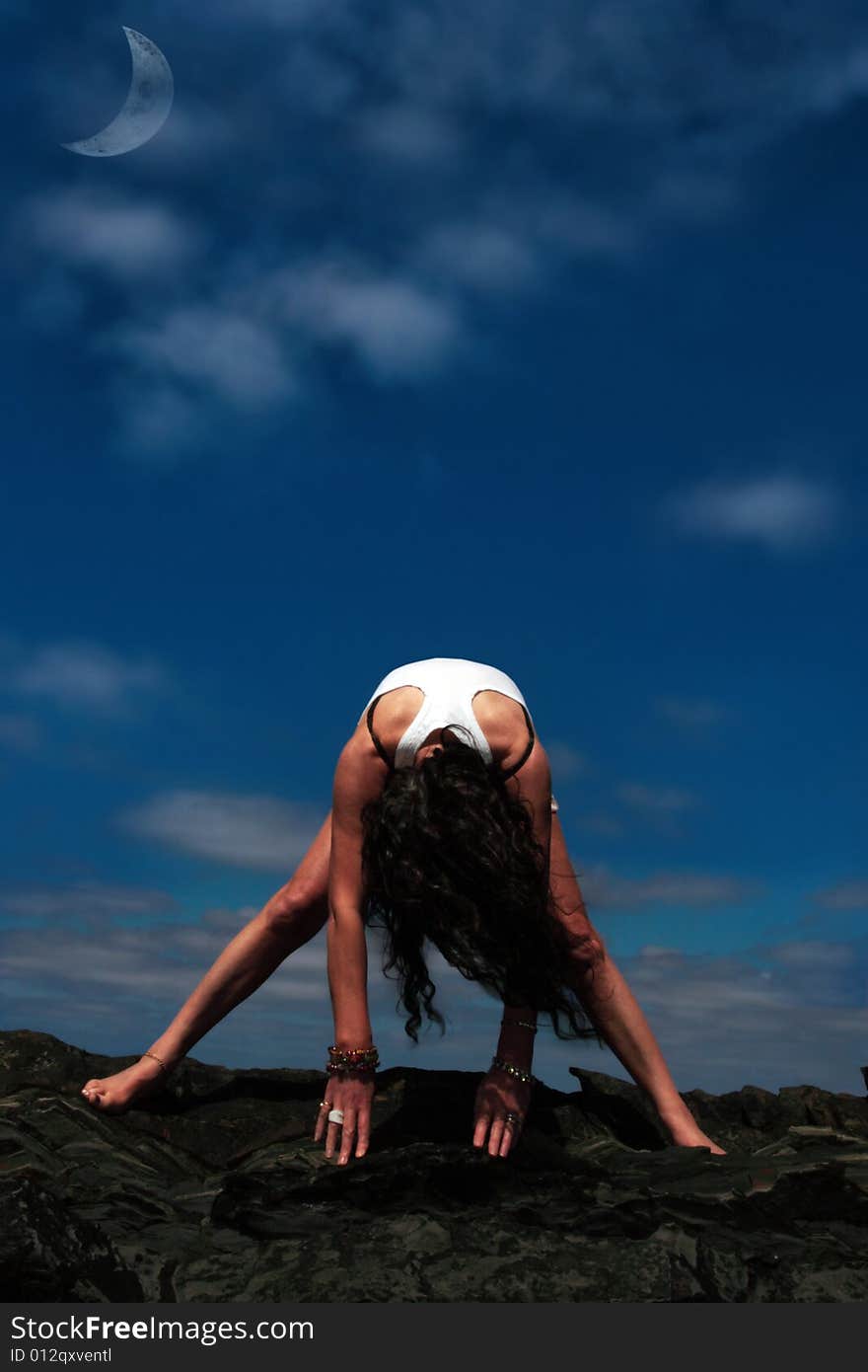 A beautiful woman doing yoga to show a healthy way to live a happy and relaxed lifestyle in a world full of stress. A beautiful woman doing yoga to show a healthy way to live a happy and relaxed lifestyle in a world full of stress