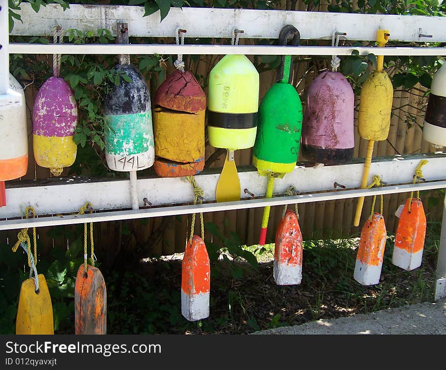 Used buoys hang waiting to be used again showing their colors and skinned paint. Used buoys hang waiting to be used again showing their colors and skinned paint.