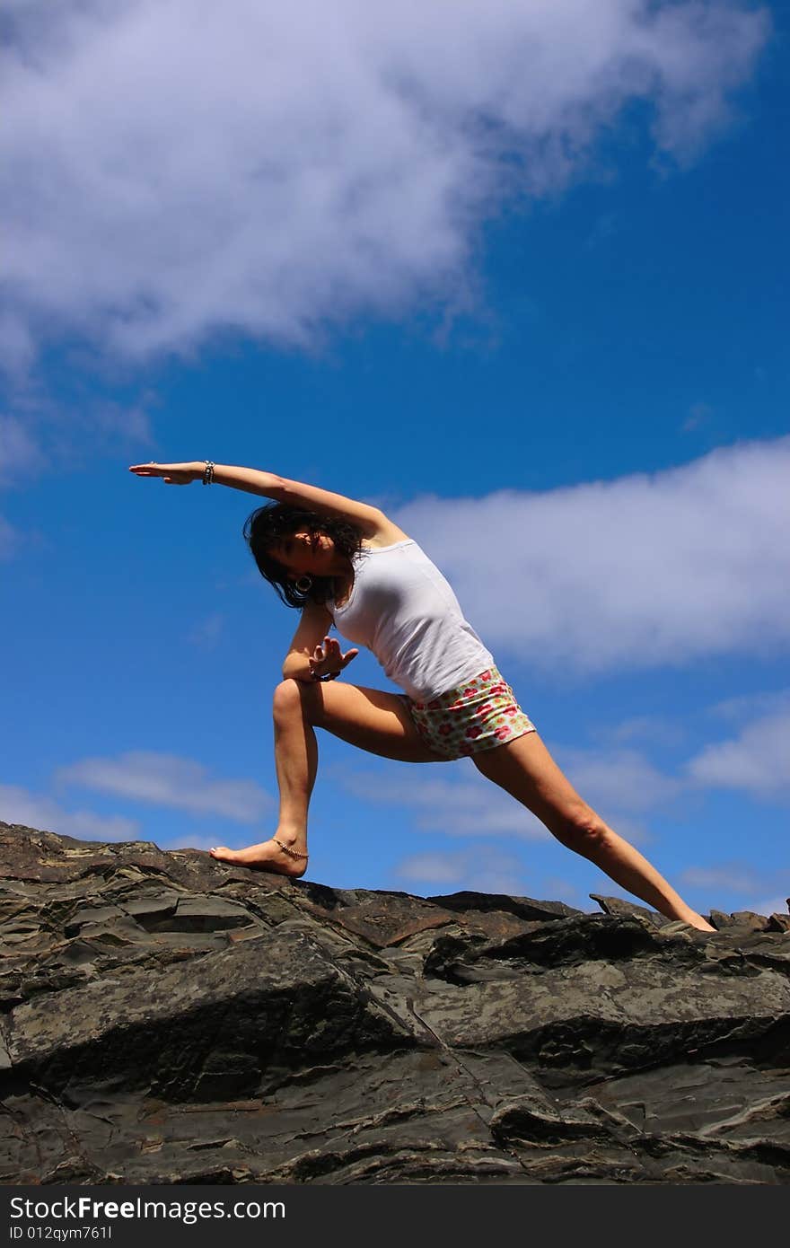 A beautiful woman doing yoga to show a healthy way to live a happy and relaxed lifestyle in a world full of stress. A beautiful woman doing yoga to show a healthy way to live a happy and relaxed lifestyle in a world full of stress