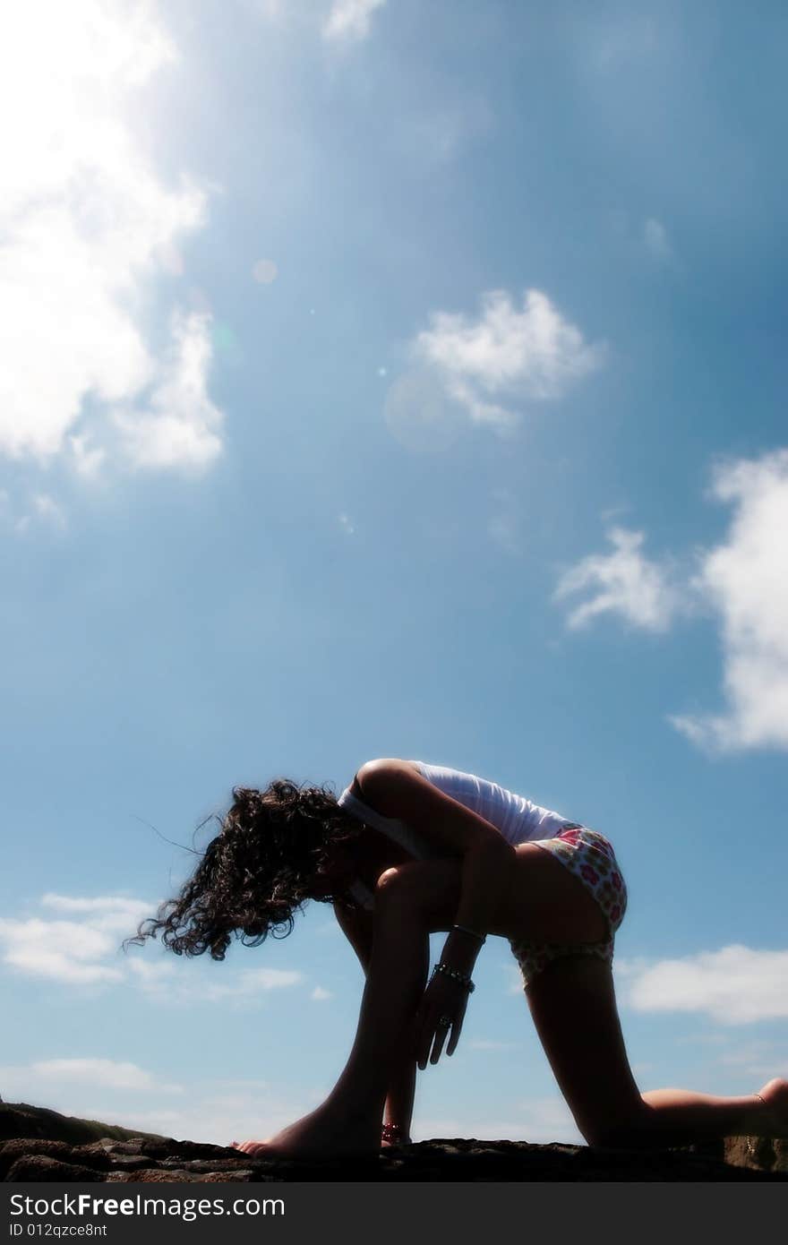 A beautiful woman doing yoga to show a healthy way to live a happy and relaxed lifestyle in a world full of stress. A beautiful woman doing yoga to show a healthy way to live a happy and relaxed lifestyle in a world full of stress