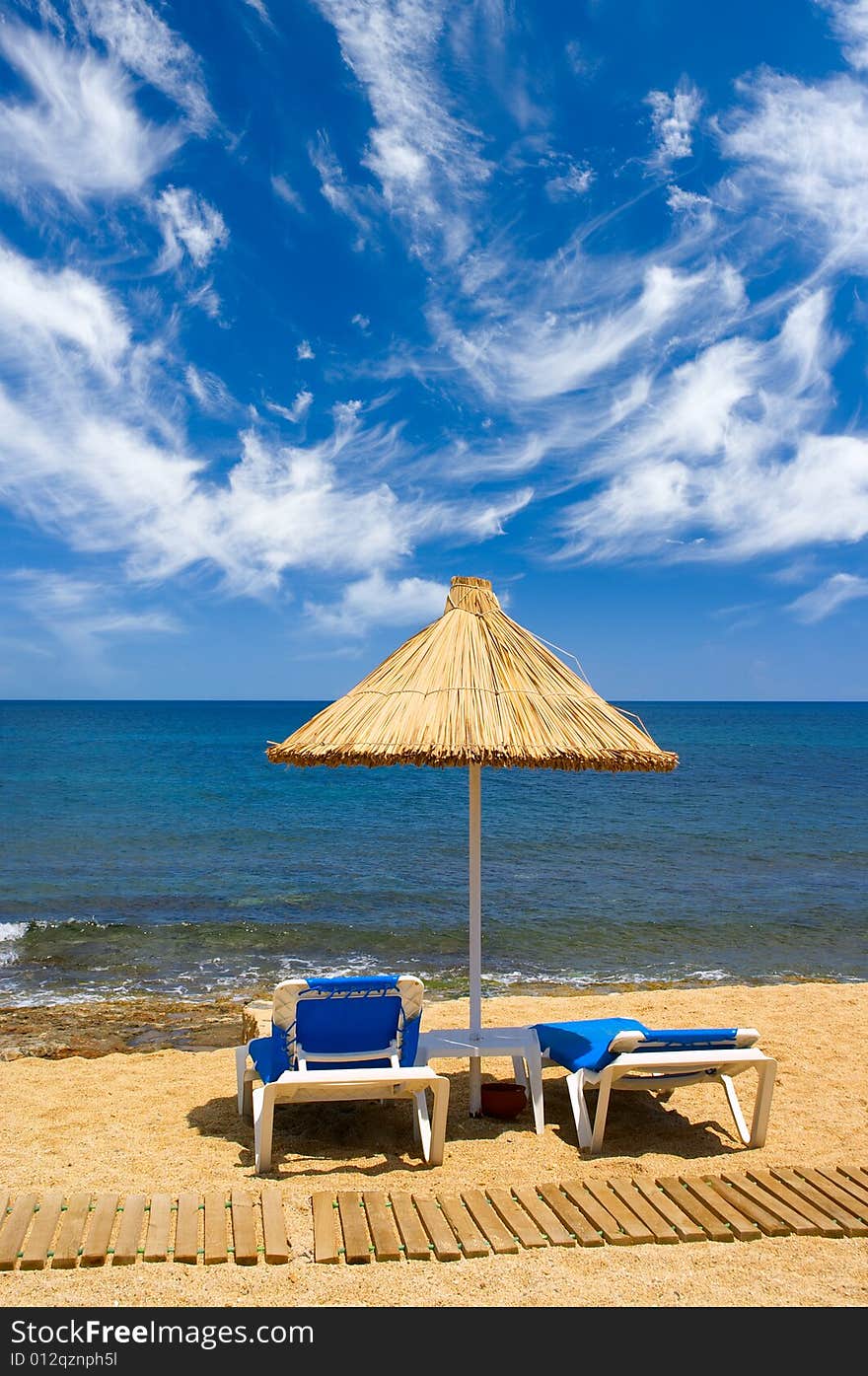 Couch and sunshade at seaside