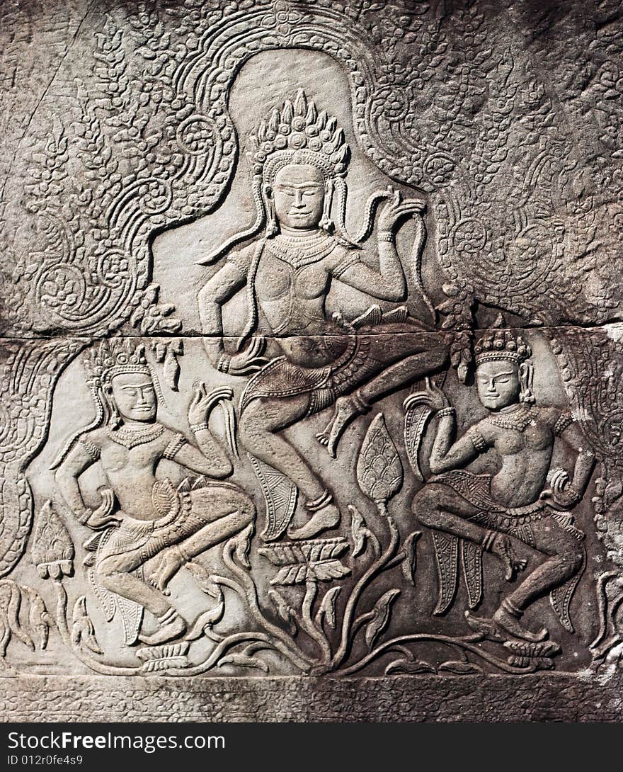 Dancing devatas - stone engraving on the wall of the Bayon Temple in Siem Reap, Cambodia