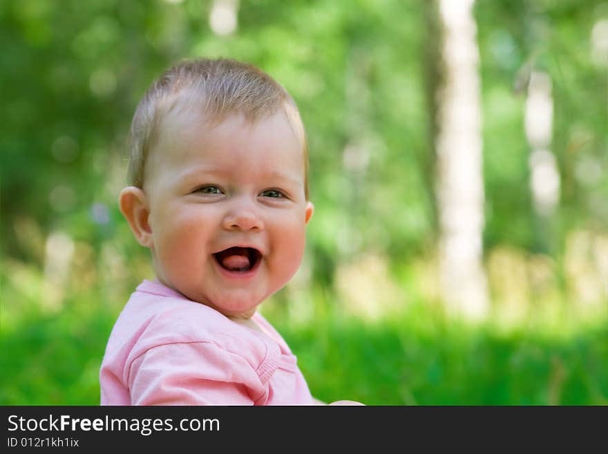 Small smiling baby in a wood #2