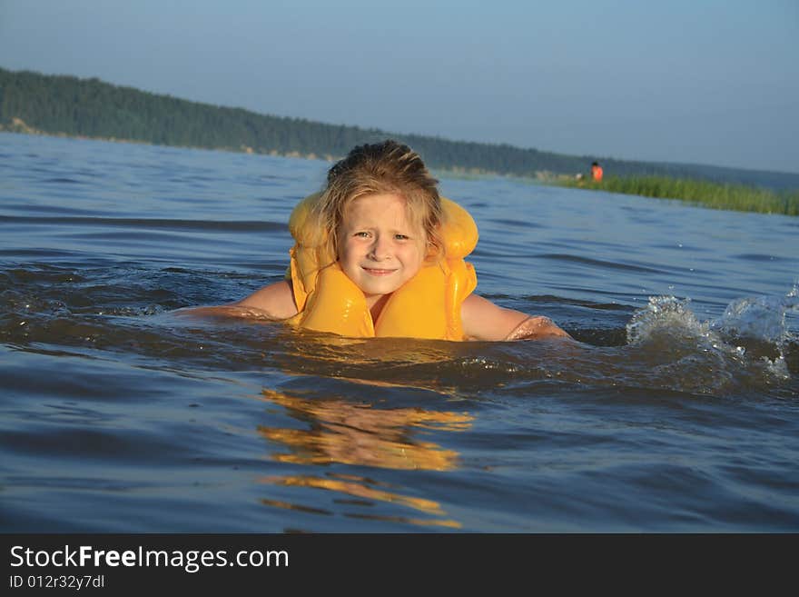 Young girl swimming in river