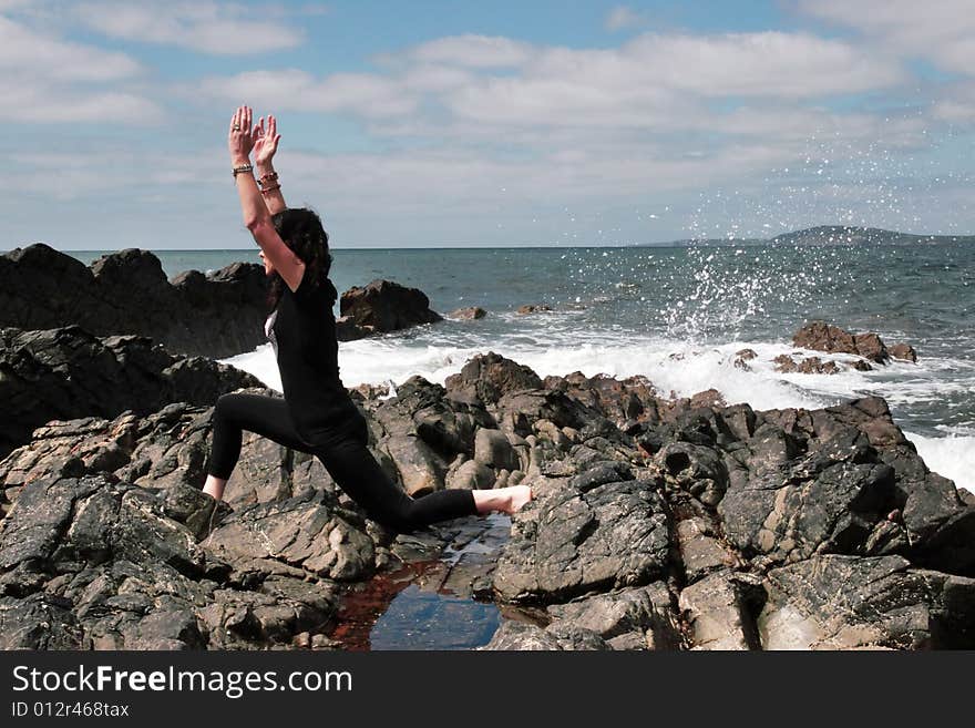 A beautiful woman doing yoga to show a healthy way to live a happy and relaxed lifestyle in a world full of stress. A beautiful woman doing yoga to show a healthy way to live a happy and relaxed lifestyle in a world full of stress