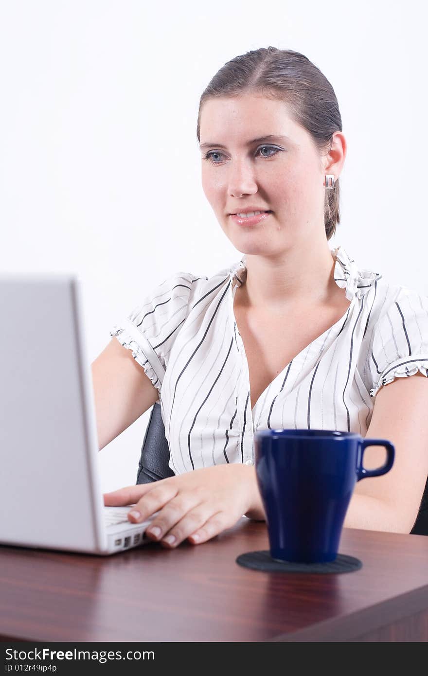 A businesswoman typing information into a laptop computer. A businesswoman typing information into a laptop computer.