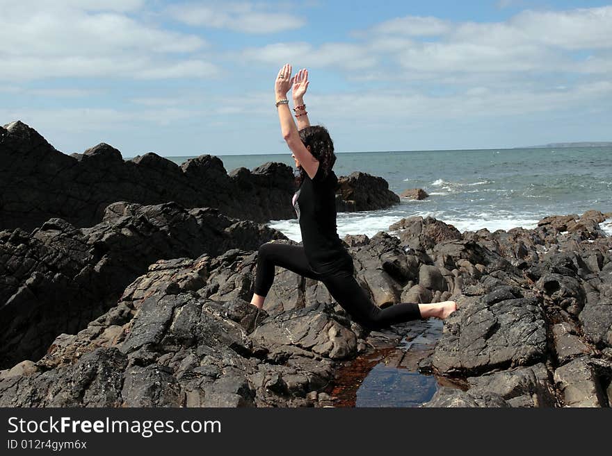 A beautiful woman doing yoga to show a healthy way to live a happy and relaxed lifestyle in a world full of stress. A beautiful woman doing yoga to show a healthy way to live a happy and relaxed lifestyle in a world full of stress