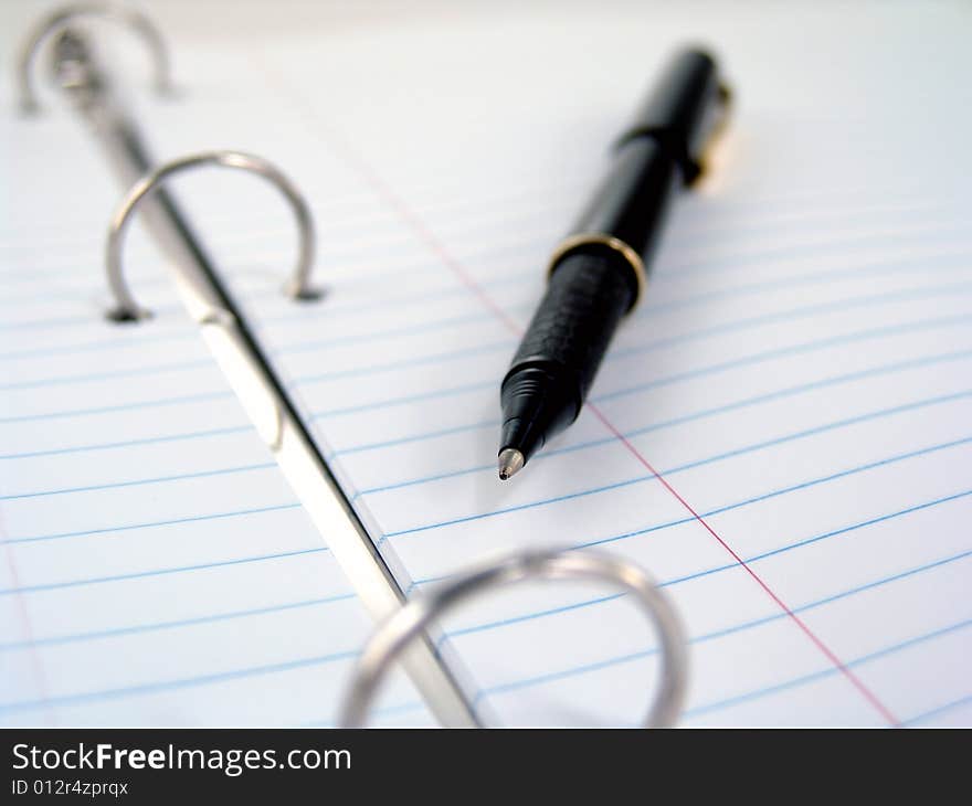 Close up of clasps in 3-ring binder with lined paper. Close up of clasps in 3-ring binder with lined paper