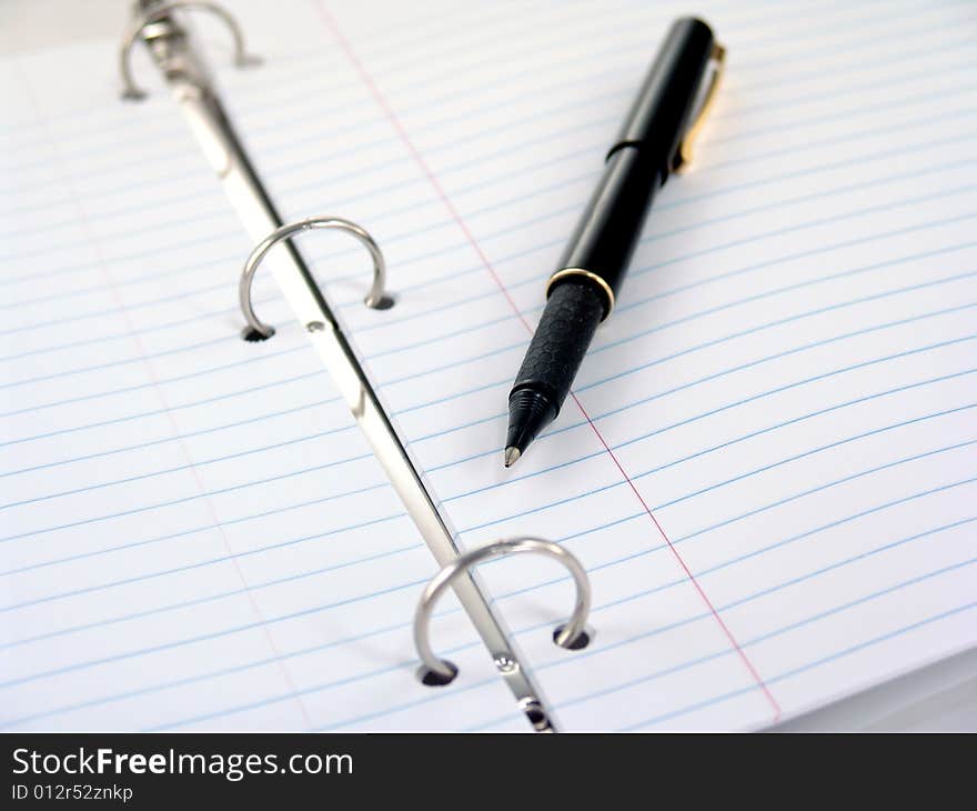 Close up of clasps in 3-ring binder with lined paper. Close up of clasps in 3-ring binder with lined paper