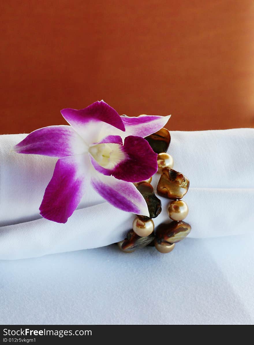 Close-up of an orchid with precious stones.