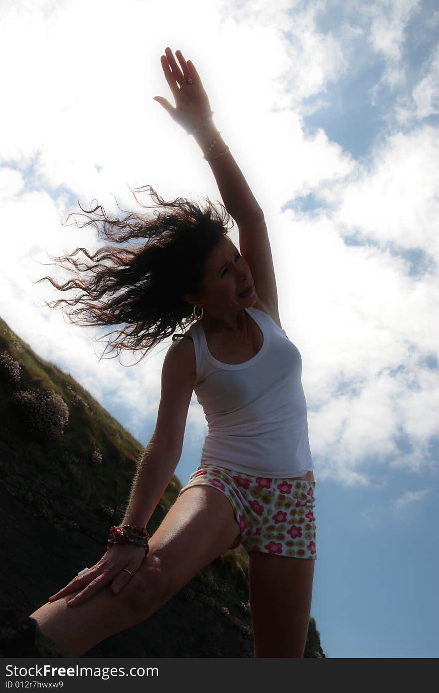 A beautiful woman doing yoga to show a healthy way to live a happy and relaxed lifestyle in a world full of stress. A beautiful woman doing yoga to show a healthy way to live a happy and relaxed lifestyle in a world full of stress