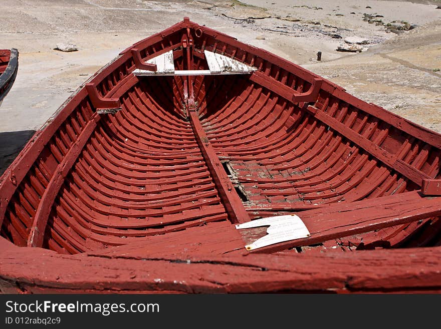 An old abandoned fishing boat, lying on dry dock in Hermanus harbor