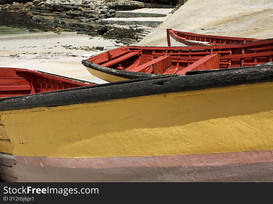 Three old abandoned fishing boat, lying on dry dock in Hermanus harbor. Three old abandoned fishing boat, lying on dry dock in Hermanus harbor