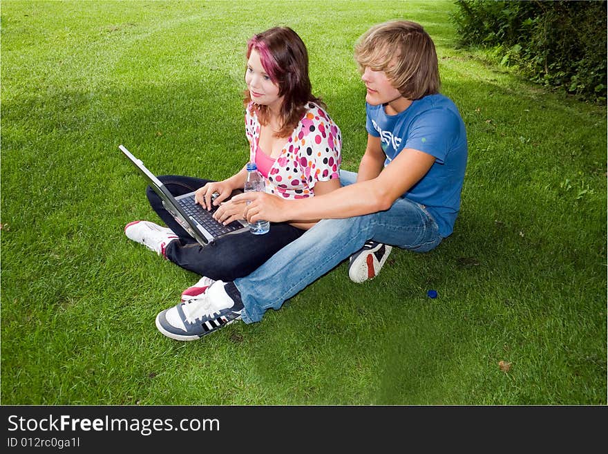 Students studying in a park in the summertime. Students studying in a park in the summertime