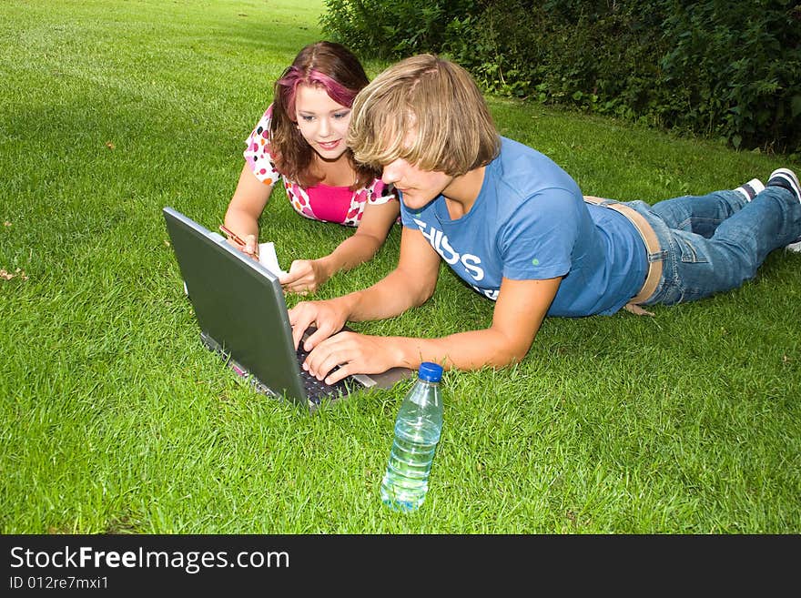 Students studying in a park in the summertime. Students studying in a park in the summertime