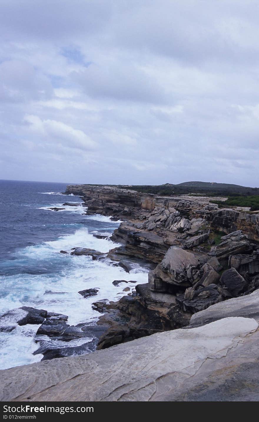 The sea beats against the rocky coast. The sea beats against the rocky coast