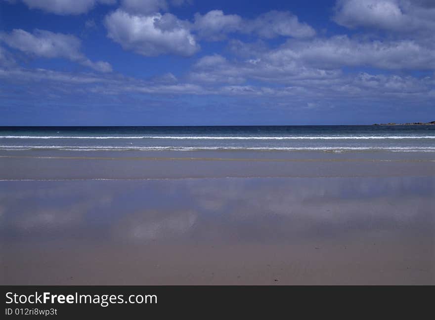 The blue sky,the clouds mirrored on the seaside. The blue sky,the clouds mirrored on the seaside.