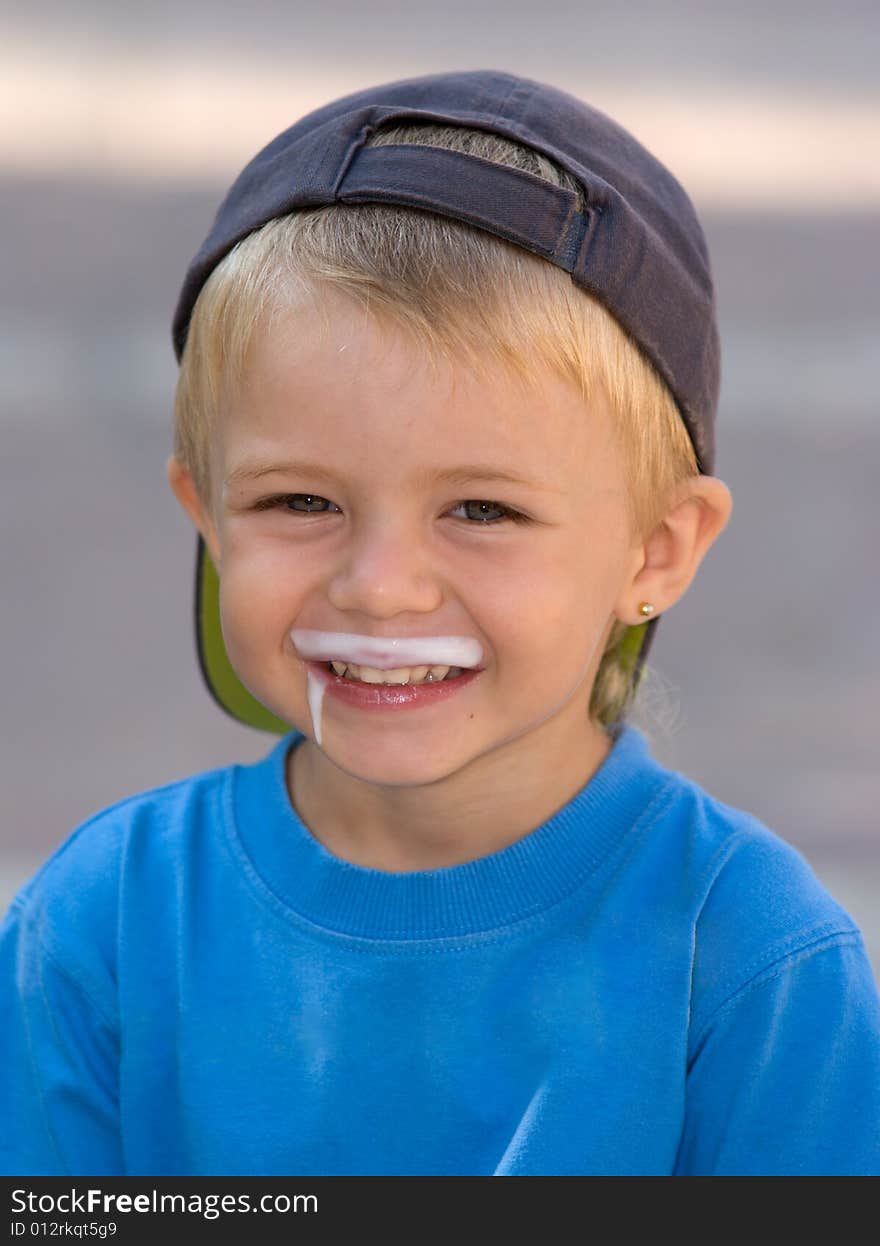 The smiling boy with milk on the lips.