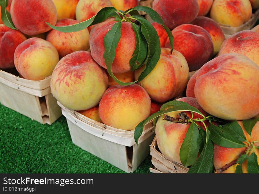 Fresh peaches in boxes at the market. Fresh peaches in boxes at the market.