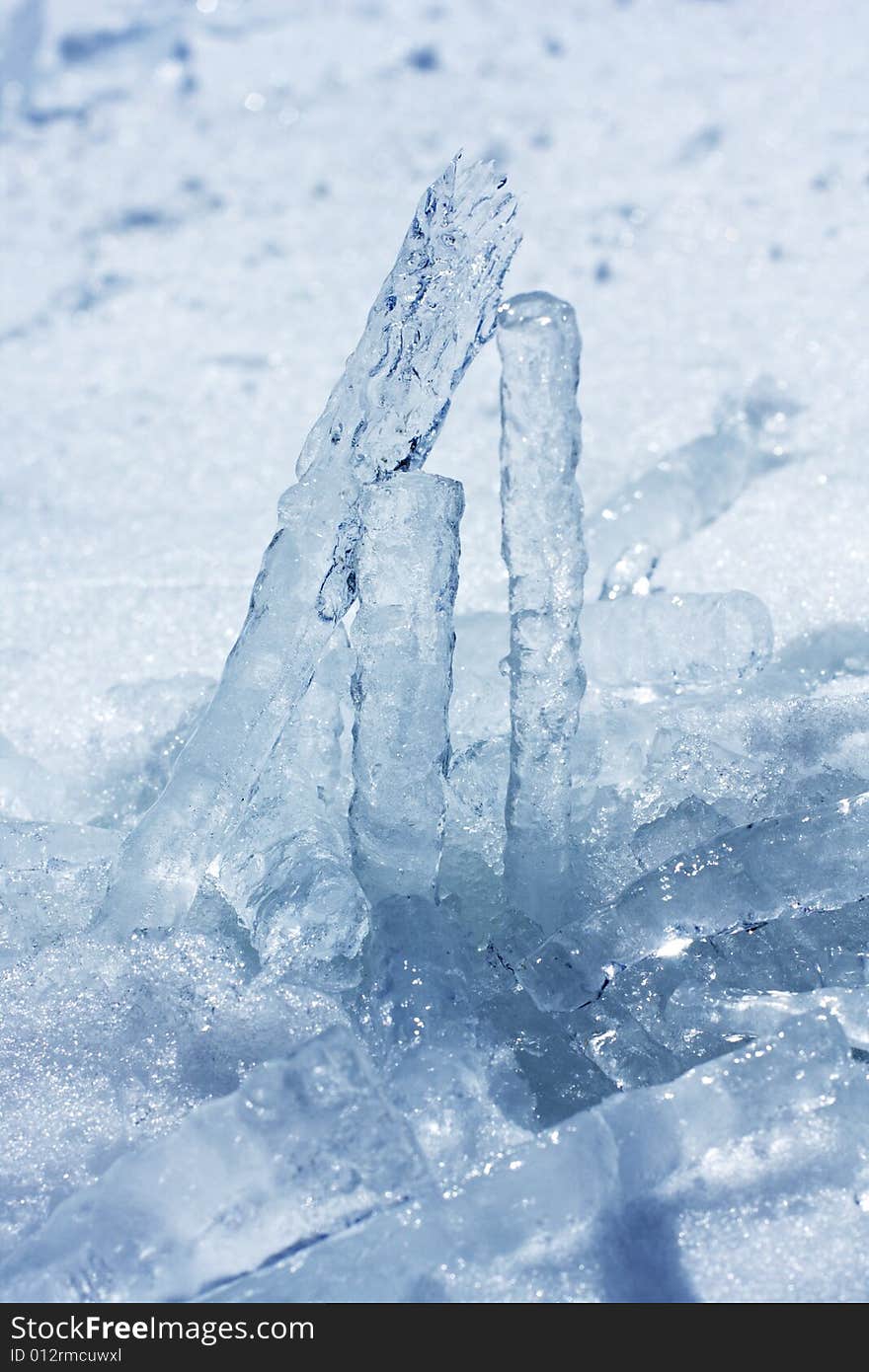 Fallen icicles frozen together to form a pattern.