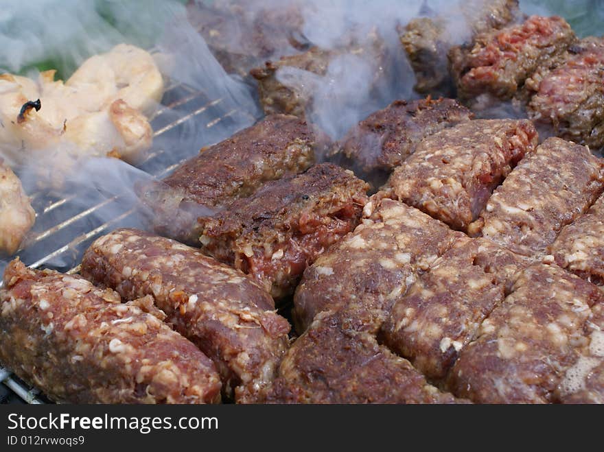 Romanian meat specialities named mici on the barbecue. Romanian meat specialities named mici on the barbecue