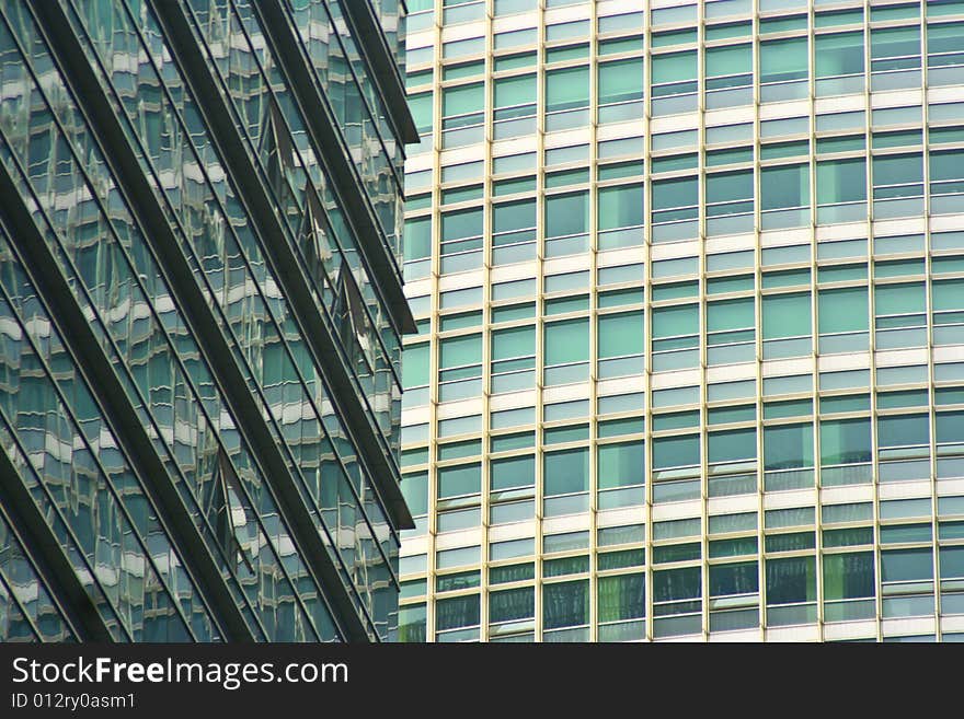 Modern cityscape with two high rising buildings, one reflected in the other. Modern cityscape with two high rising buildings, one reflected in the other.