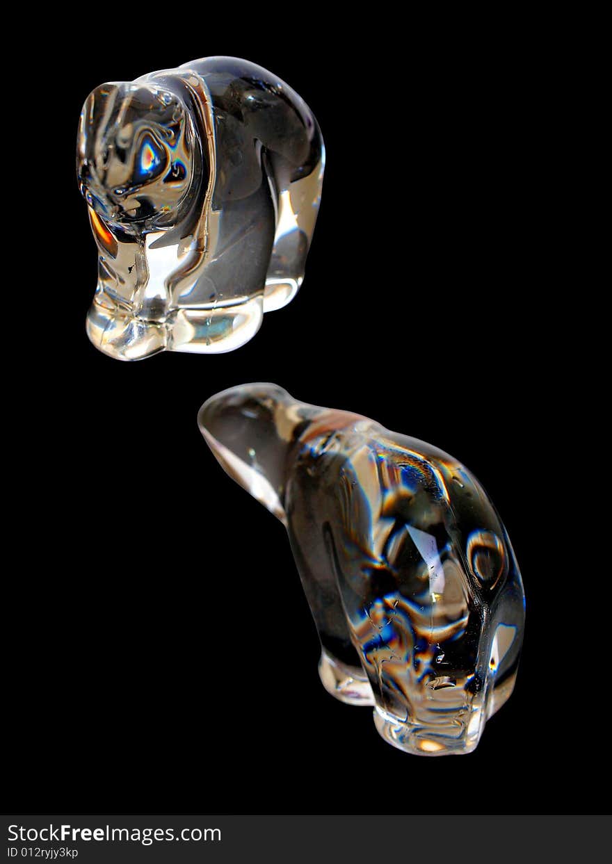 Two Translucent Crystal Polar Bears isolated in black background facing each other. Two Translucent Crystal Polar Bears isolated in black background facing each other