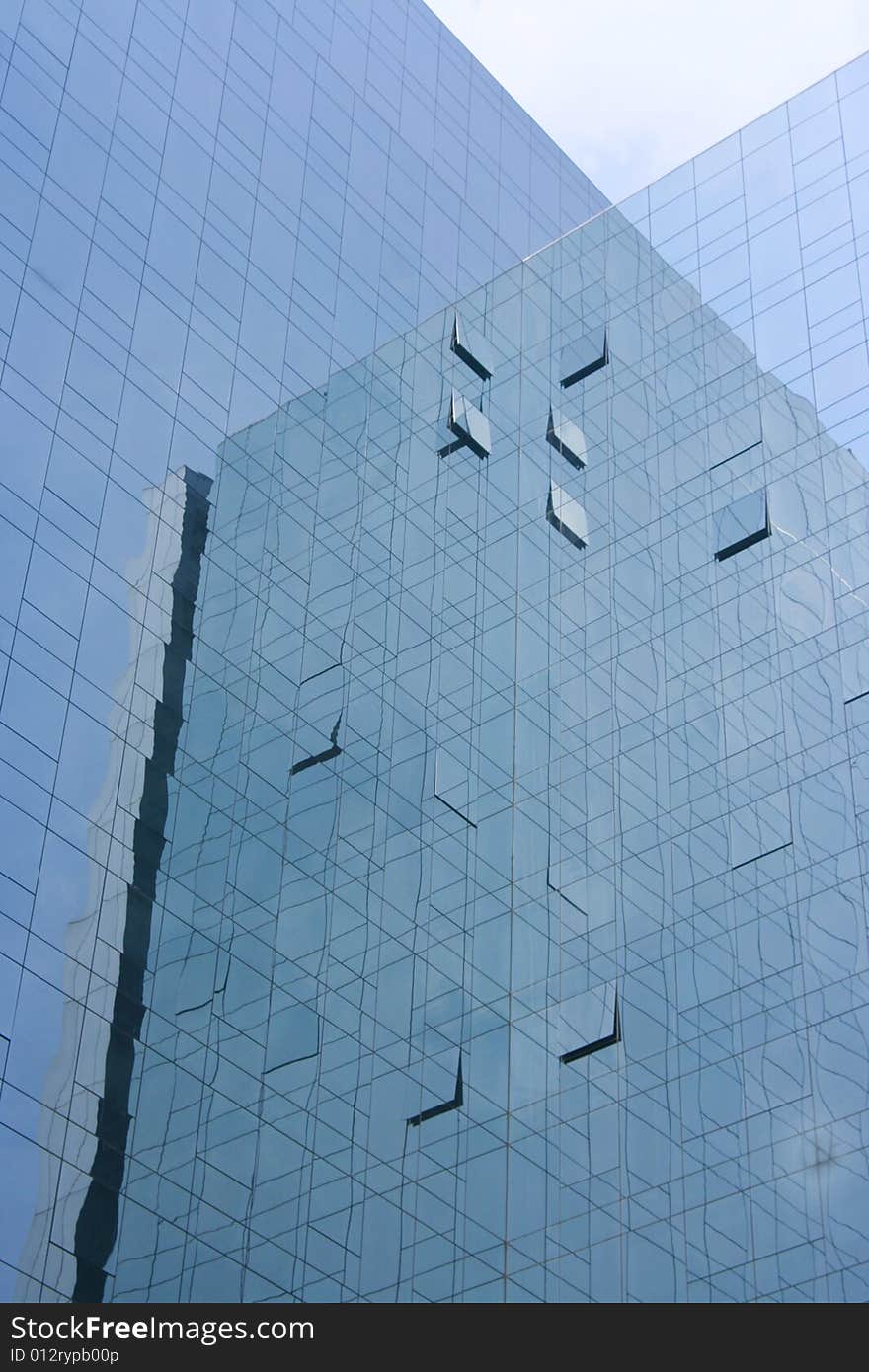 View at the modern high-risers reflecting the sky in its windows.