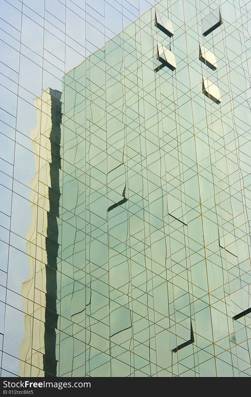 Reflections of a modern skyscraper in light blue and aquamarine color. Reflections of a modern skyscraper in light blue and aquamarine color.