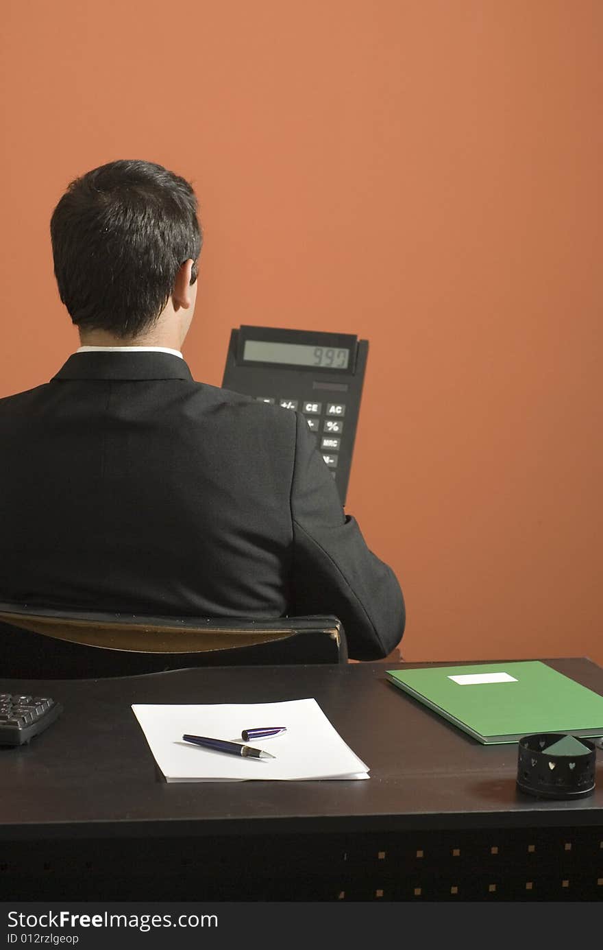 Businessman  with Giant Calculator - Vertical