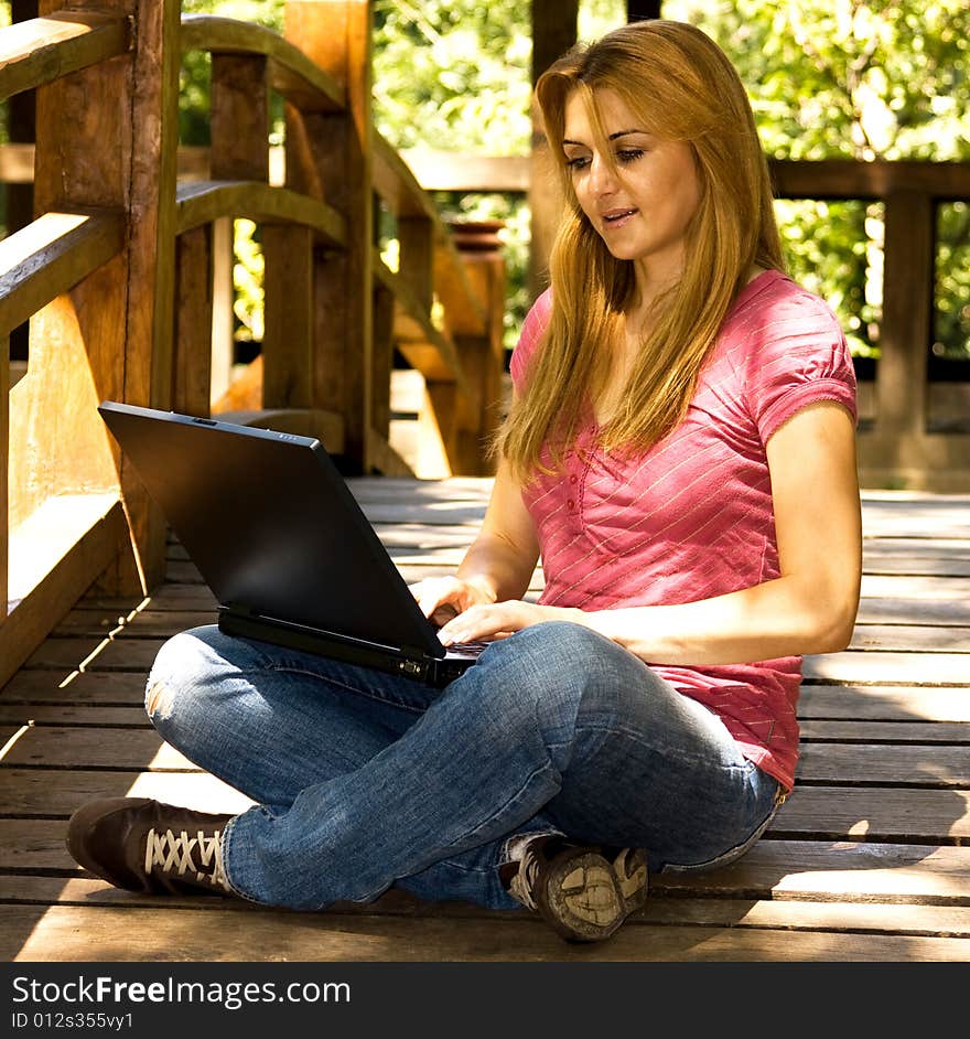 Beautiful young student using laptop outdoor. Beautiful young student using laptop outdoor.