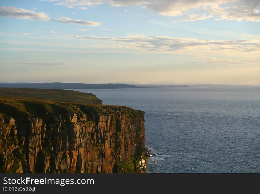 The cliffs and coastline of northern scotland at sunset. The cliffs and coastline of northern scotland at sunset.