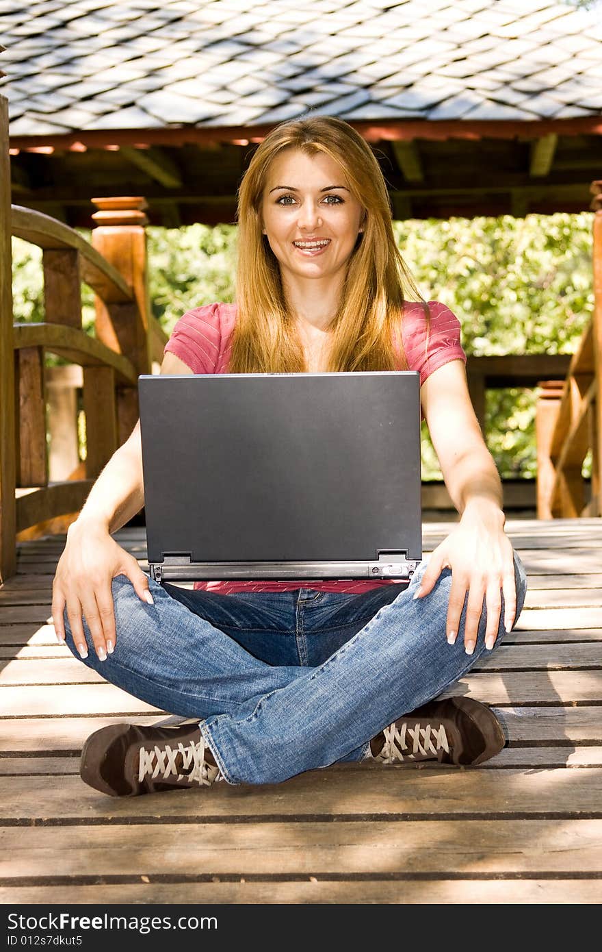 Beautiful young student using laptop outdoor. Beautiful young student using laptop outdoor.