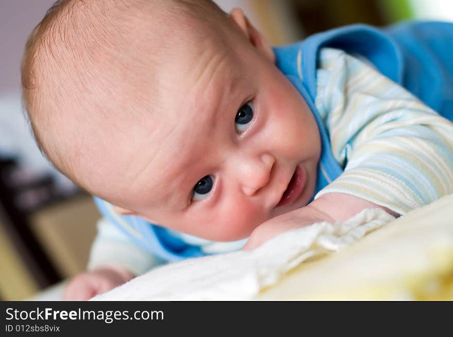 Eight week baby lying on his belly and struggling to keep head up. Eight week baby lying on his belly and struggling to keep head up.