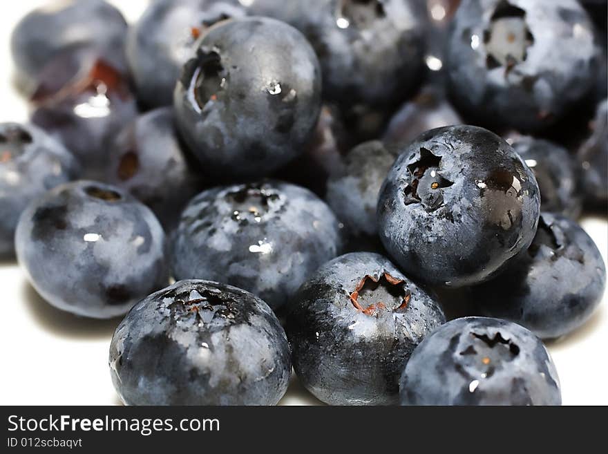 Macro shot of blueberries isolated against white background. Macro shot of blueberries isolated against white background