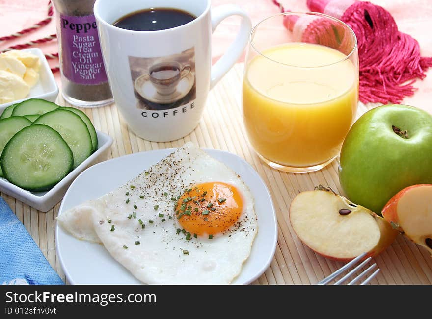 Fresh breakfast with an egg, fruits, bread and vegetables