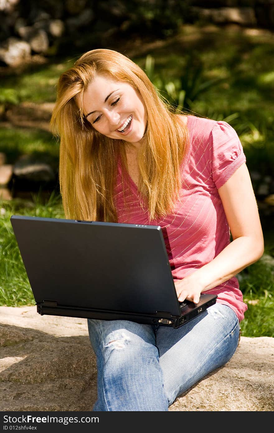 Happy young student using laptop in natural environment. Happy young student using laptop in natural environment.