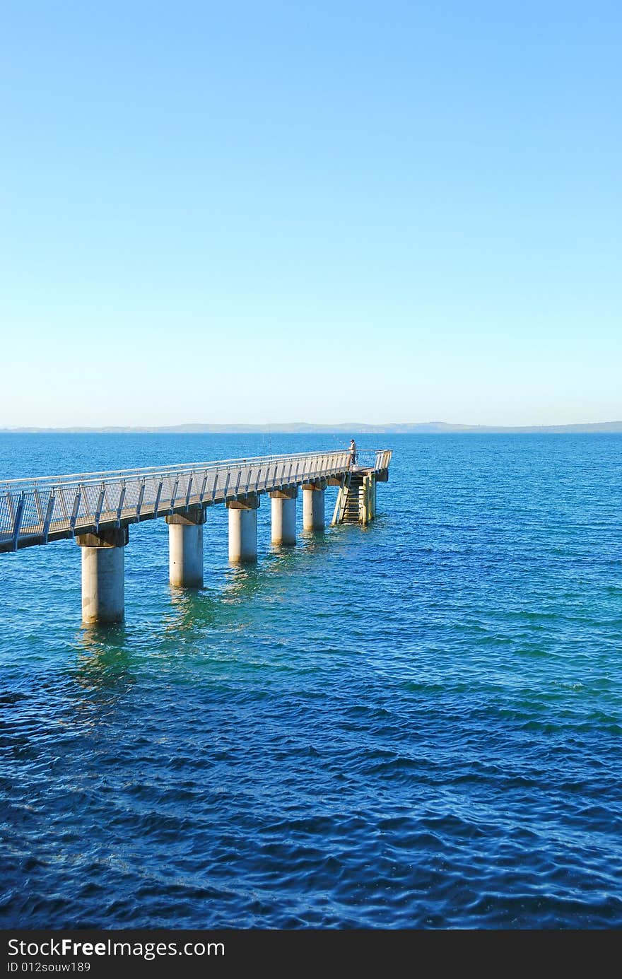 a man fishing on wharf