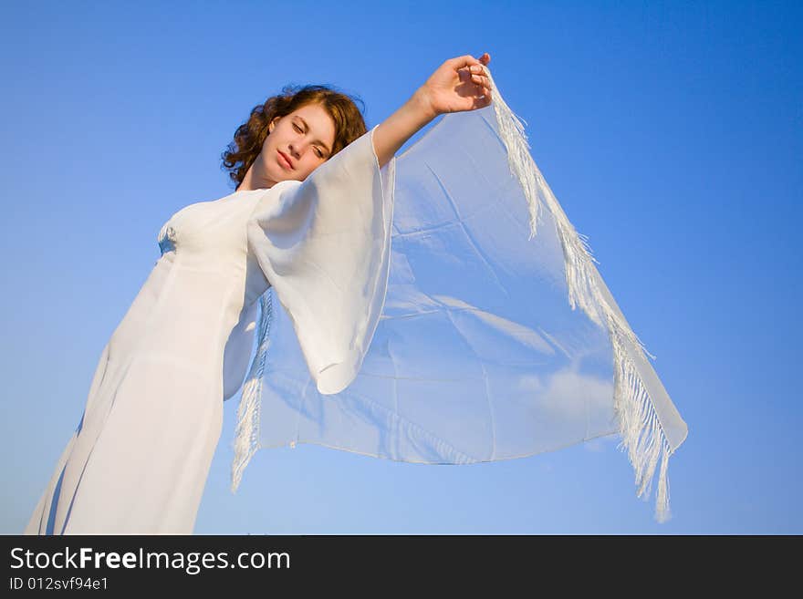 Young woman against a background blue sky. Young woman against a background blue sky