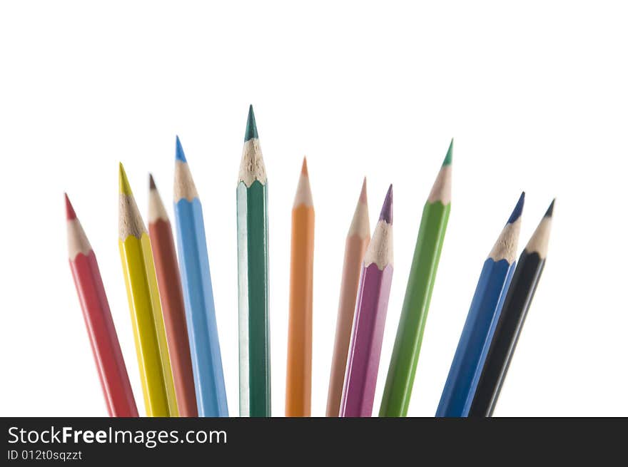 Eleven color pencils upright on a white background